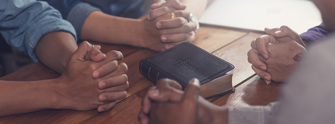 holding hands and Bible